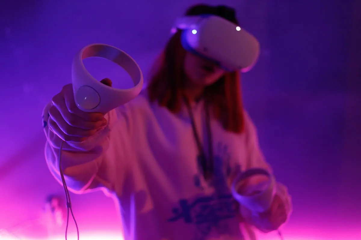 A person in a mixed reality headset reaching out with a controller